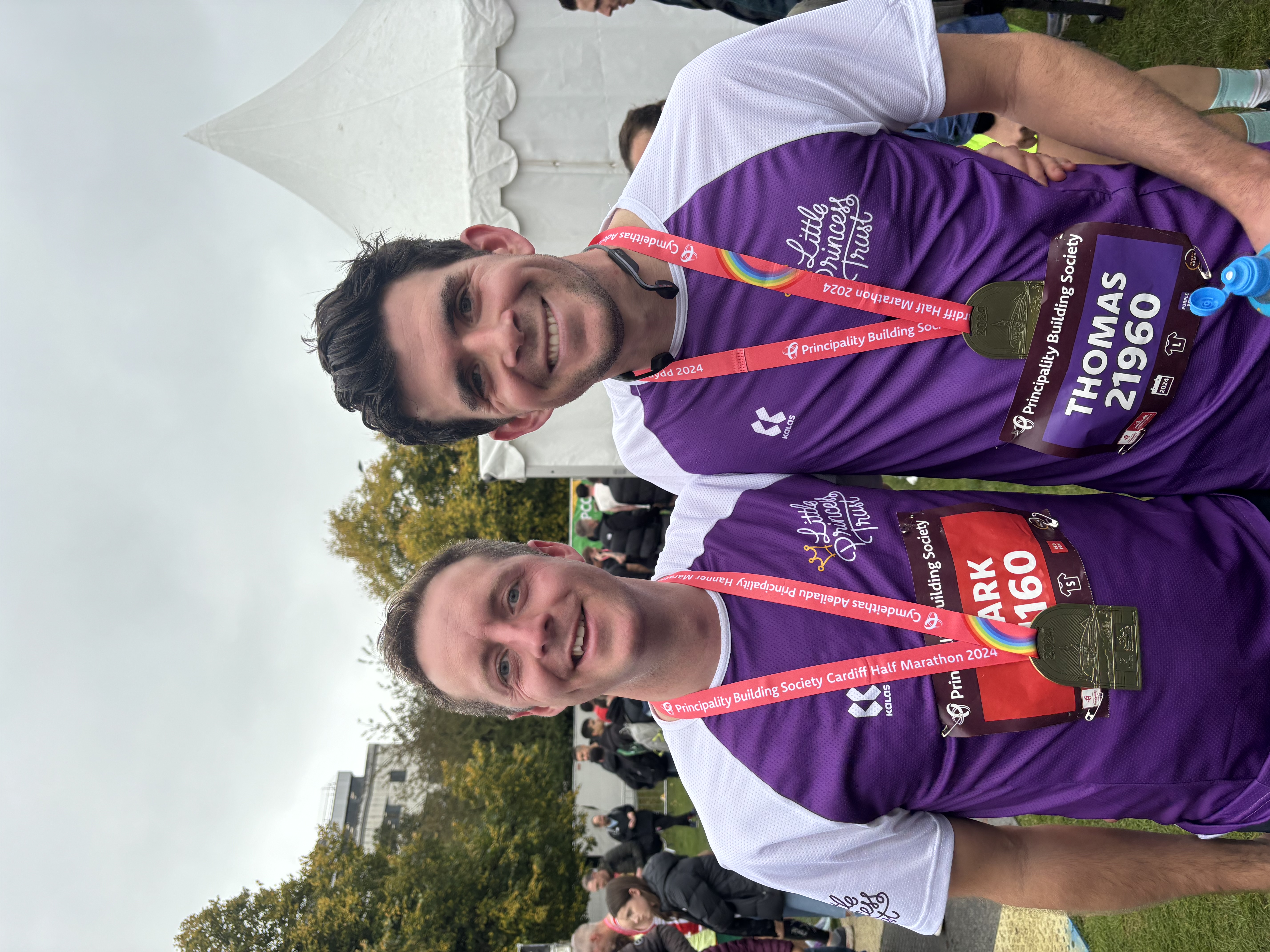 Two LPT runners with their medals after completing the race