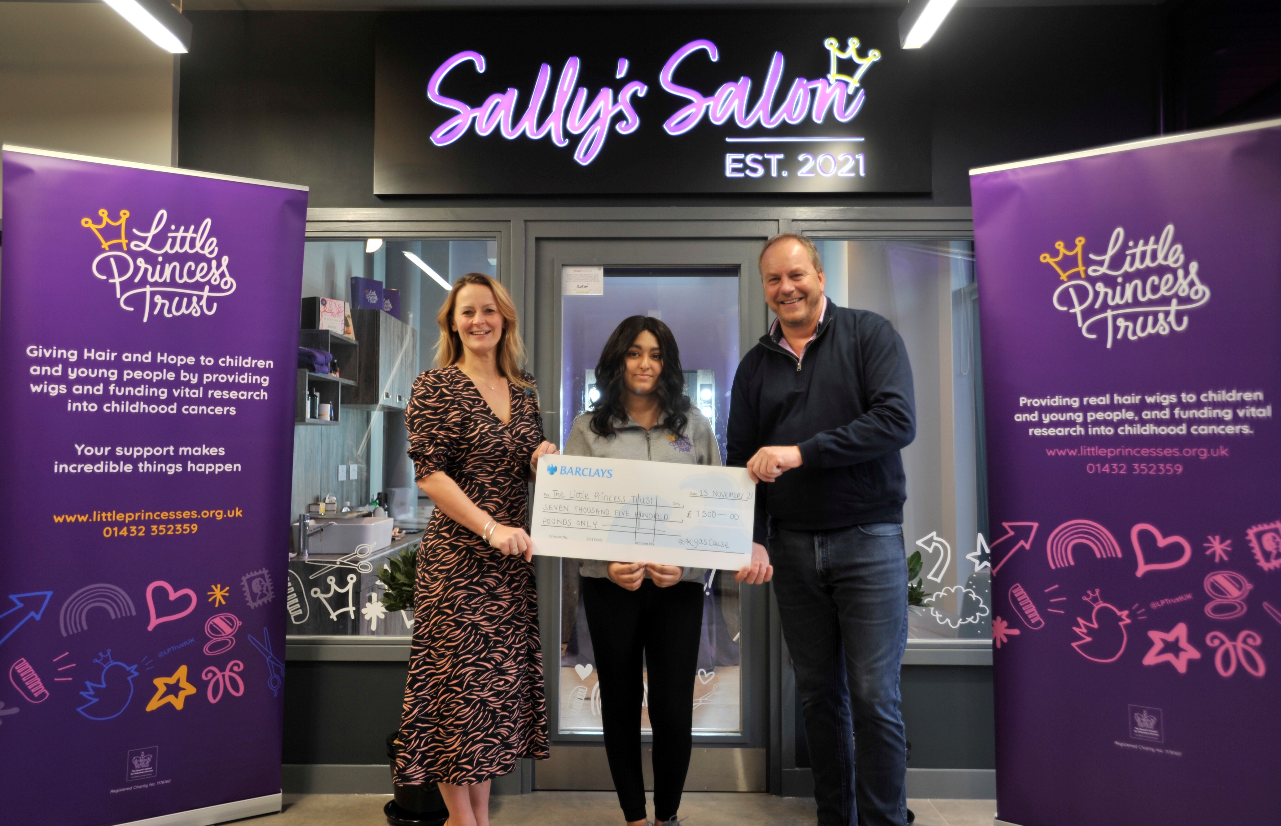 Wendy Tarplee-Morris and Phil Brace thank Kiya (middle) after she raised thousands of pounds for The Little Princess Trust.